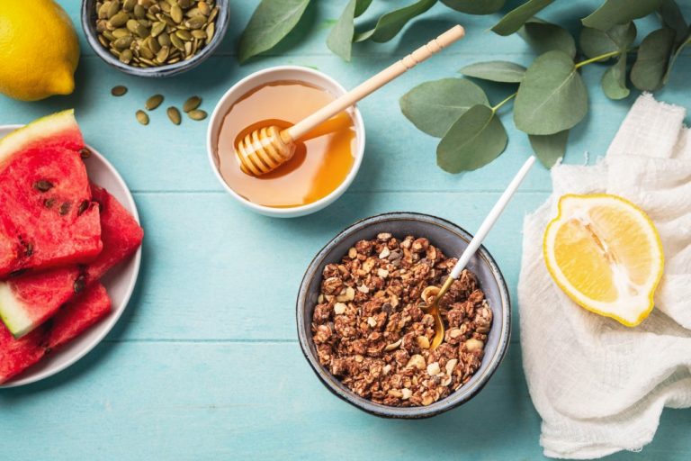 fresh-healthy-breakfast-granola-honey-watermelon-lemon-top-view-blue-wooden-background-copy-space_t20_KvbaO9